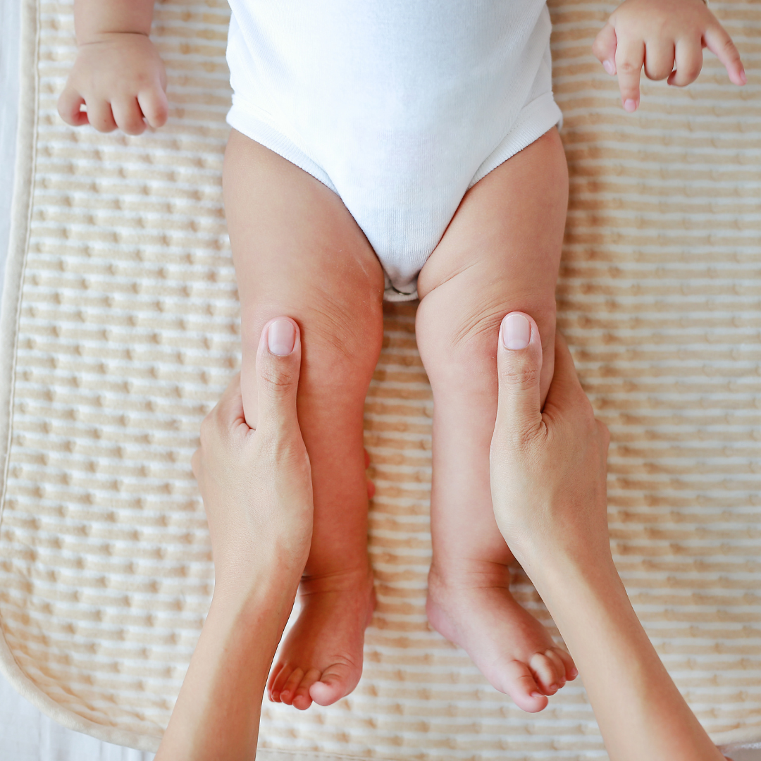 a baby being massaged by a person